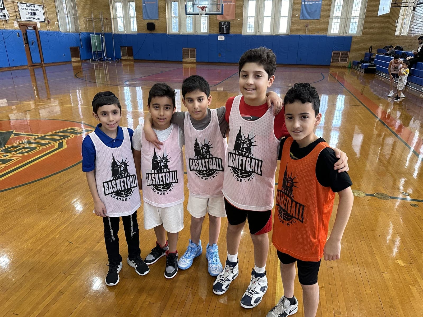 Teammates with arms around each other's shoulders after a game